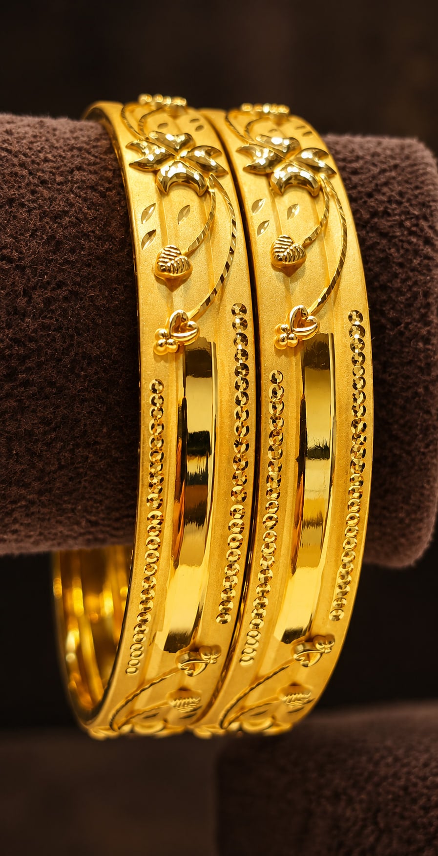 Pair of gold bangles with carved detailing